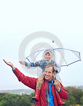 Rain, umbrella and father with child for family portrait outdoor for fun, happiness and quality time. Man and boy kid in