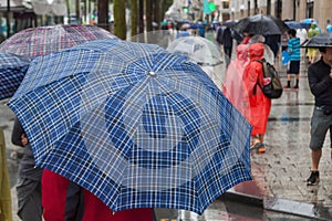 With rain umbrella in the rainy city