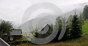 Rain in the village in mountain, summer day. Slow motion