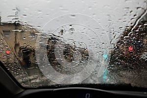 Rain water on a car windscreen affecting road visibility