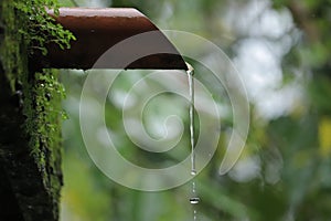 Water dropping from orange pipe