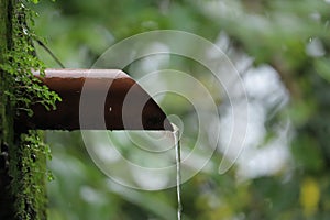 Water dropping from orange pipe