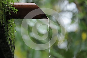 Water dropping from orange pipe