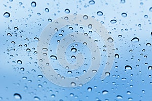 Rain water drops blue glass
