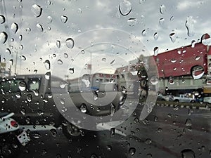 Rain water drops texture on a car glass surface. Rain water drops on car