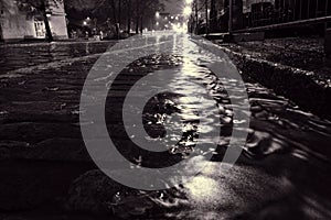 Rain water flowing on a cobblestone street in Helsinki