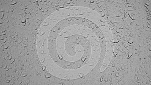 Rain weather wet car glass, dusty window with raindrops, rain water rain, backdrop drop texture background. Textured wet surface