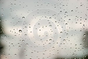 Rain on window with blurred background