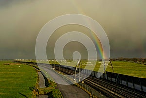 Rainbow above an empty railroad track near Sliedrecht