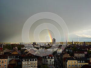 Rainbow above Mulhouse: Europe's City of Beautiful Cloudy Skies, Tower Silhouettes, and a Heavy Rain