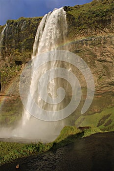 A rainbow above the waterfall in Iceland - Seljalandsfoss