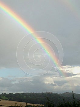 Rainbow across blue sky over Hardwick Hall