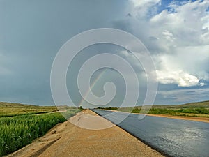 A rainbow appeared over the track, an asphalt road.