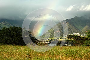 A rainbow appears over a farm in Maui, Hawaii