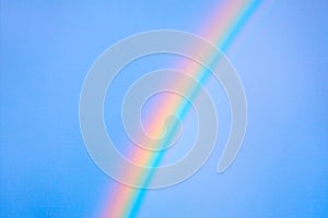 Rainbow arc across the blue sky