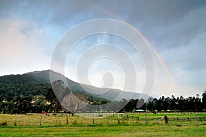 Rainbow arc over the mountain of Gold Coast Hinterland