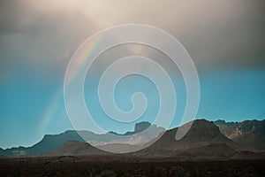 Rainbow Arches Over Chisos Mountains In Big Bend