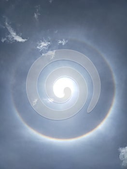 Rainbow around the sun.blue sky.