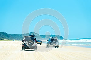 4wd vehicles at Rainbow Beach with coloured sand dunes, QLD, Australia