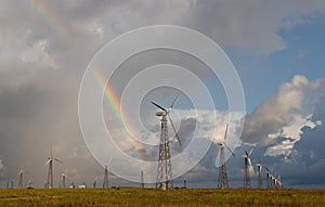 Rainbow behind wind turbines