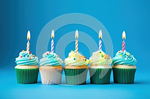 rainbow birthday cupcakes on blue background