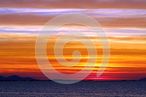 the rainbow and blue sky red orange yellow cloud in sunset on the sea