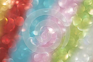 Rainbow bokeh made of defocused colorful glitter. Abstract background. Color spectrum. Pastel soft colors. Party background