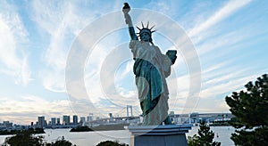 Rainbow Bridge and Statue of Liberty in Odaiba, Tokyo Japan.