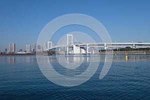 Rainbow bridge in tokyo with blue sky and sea