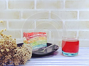 Rainbow cake slice with chocolate sauce