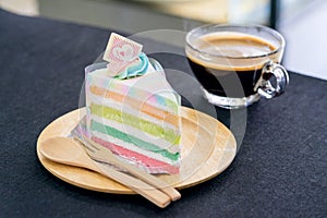 Rainbow cake on wooden plate