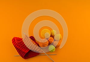 Rainbow cap made of wool on an orange background