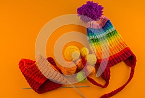 Rainbow cap made of wool on an orange background