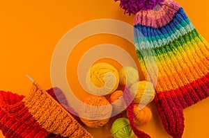 Rainbow cap made of wool on an orange background