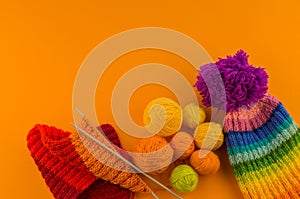 Rainbow cap made of wool on an orange background