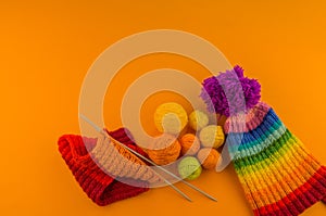 Rainbow cap made of wool on an orange background