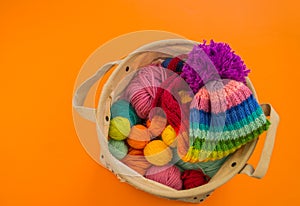 Rainbow cap made of wool on an orange background