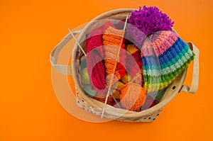 Rainbow cap made of wool on an orange background