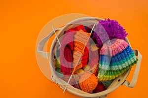 Rainbow cap made of wool on an orange background