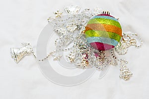 Rainbow Christmas ball with christmas chain on a white background.