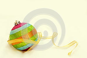 Rainbow Christmas ball with ribbon with free copy space background.