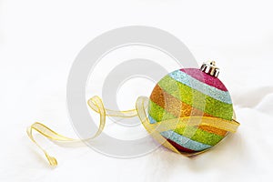 Rainbow Christmas ball with ribbon on a white background.