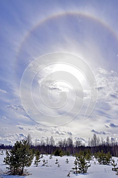 A rainbow circle halo around the sun in the sky. Spring day in the foothills of the Western Urals.