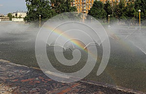 Rainbow in a city fountain