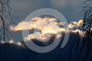 Rainbow clouds on the edge of a large cloud