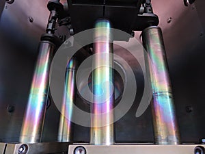 Rainbow on coated steel rods inside vacuum deposition chamber