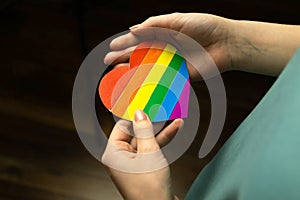 Rainbow color flag in heart shape, symbol of LGBT pride month celebrate, human rights concept photo