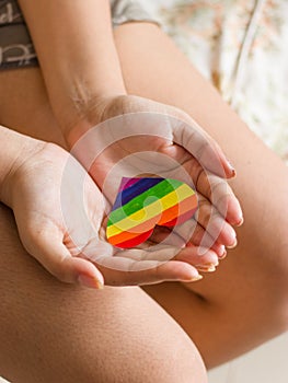 Rainbow color heart on hand for lgbtq community.
