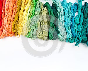 Rainbow color threads for embroidery on a white background