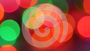 Rainbow colored bokeh abstract background. Abstract colored circles defocused christmas lights on dark background.